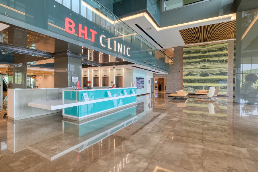 BHT Clinic Tema main lobby — marble floors, reception desk under the clinic signage.
